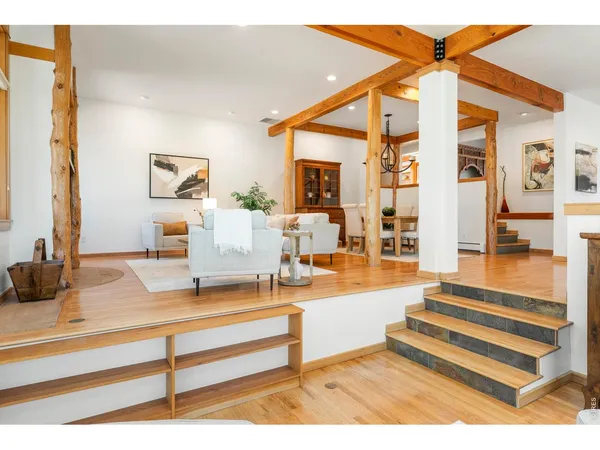 a view of living room with furniture and wooden floor