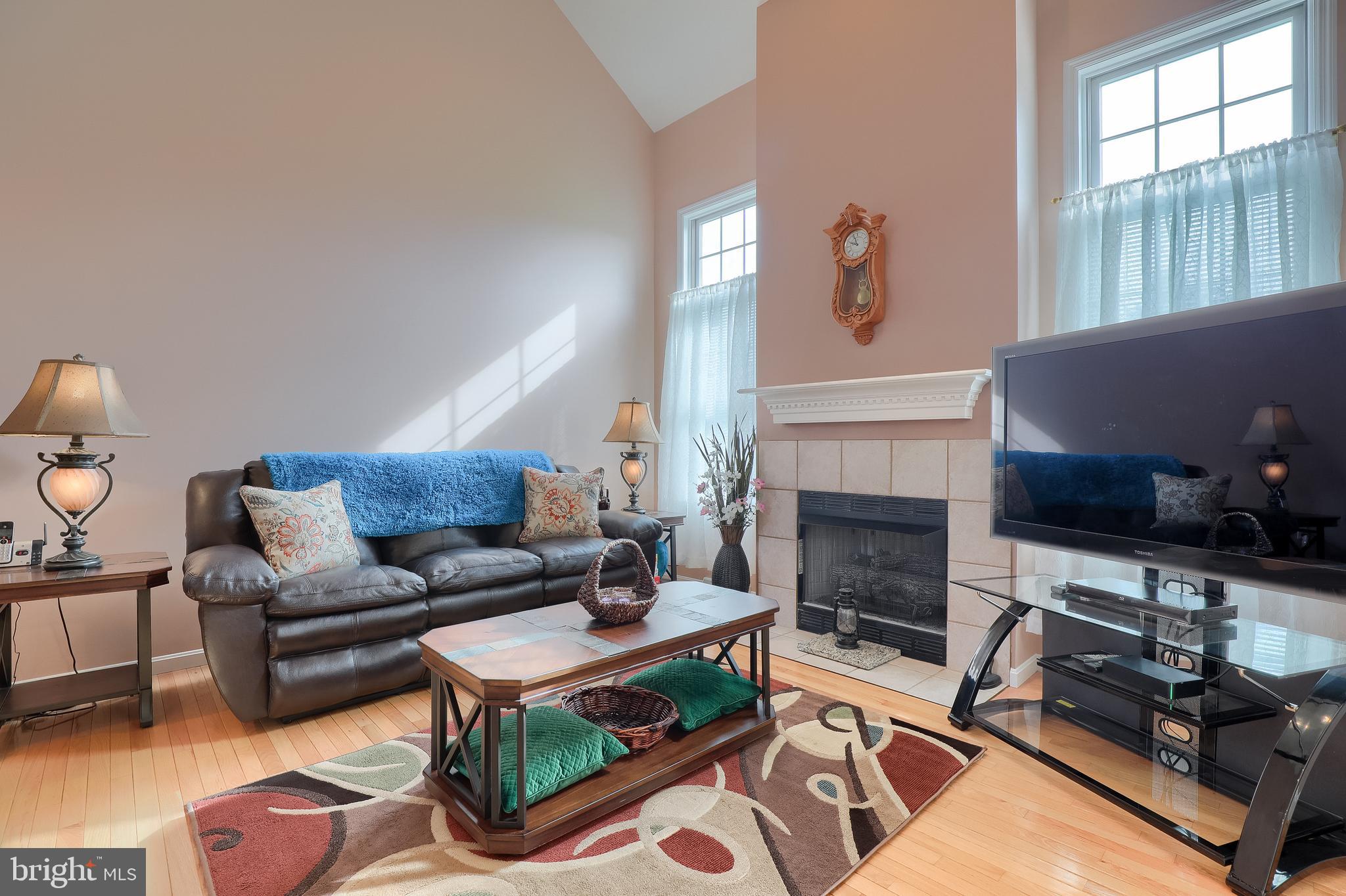 430 Wagonwheel Road Lititz, PA 17543 - Photo 13 of 51 a living room with furniture a flat screen tv and a fireplace