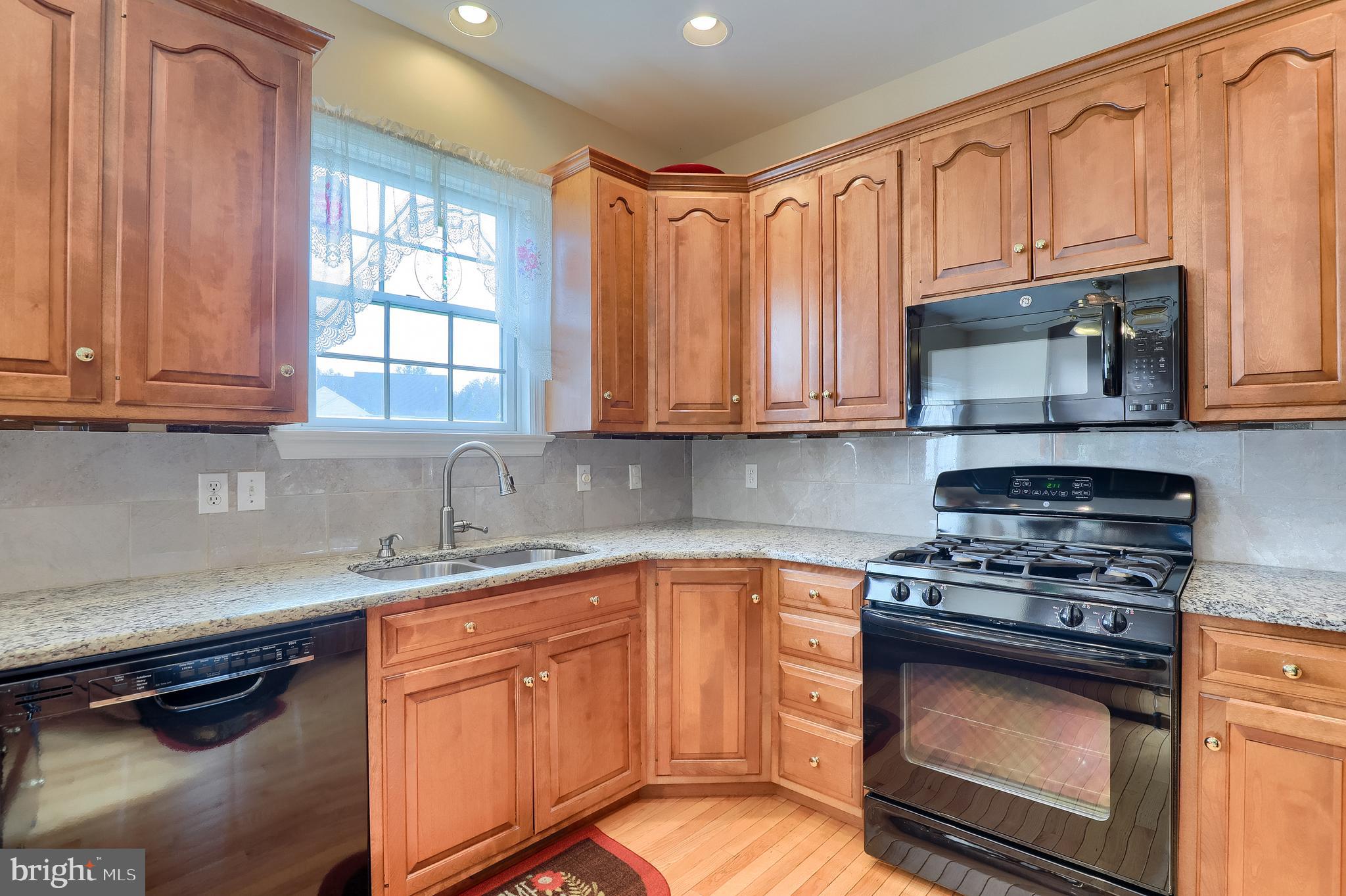 430 Wagonwheel Road Lititz, PA 17543 - Photo 20 of 51 a kitchen with stainless steel appliances granite countertop a stove a sink and a microwave