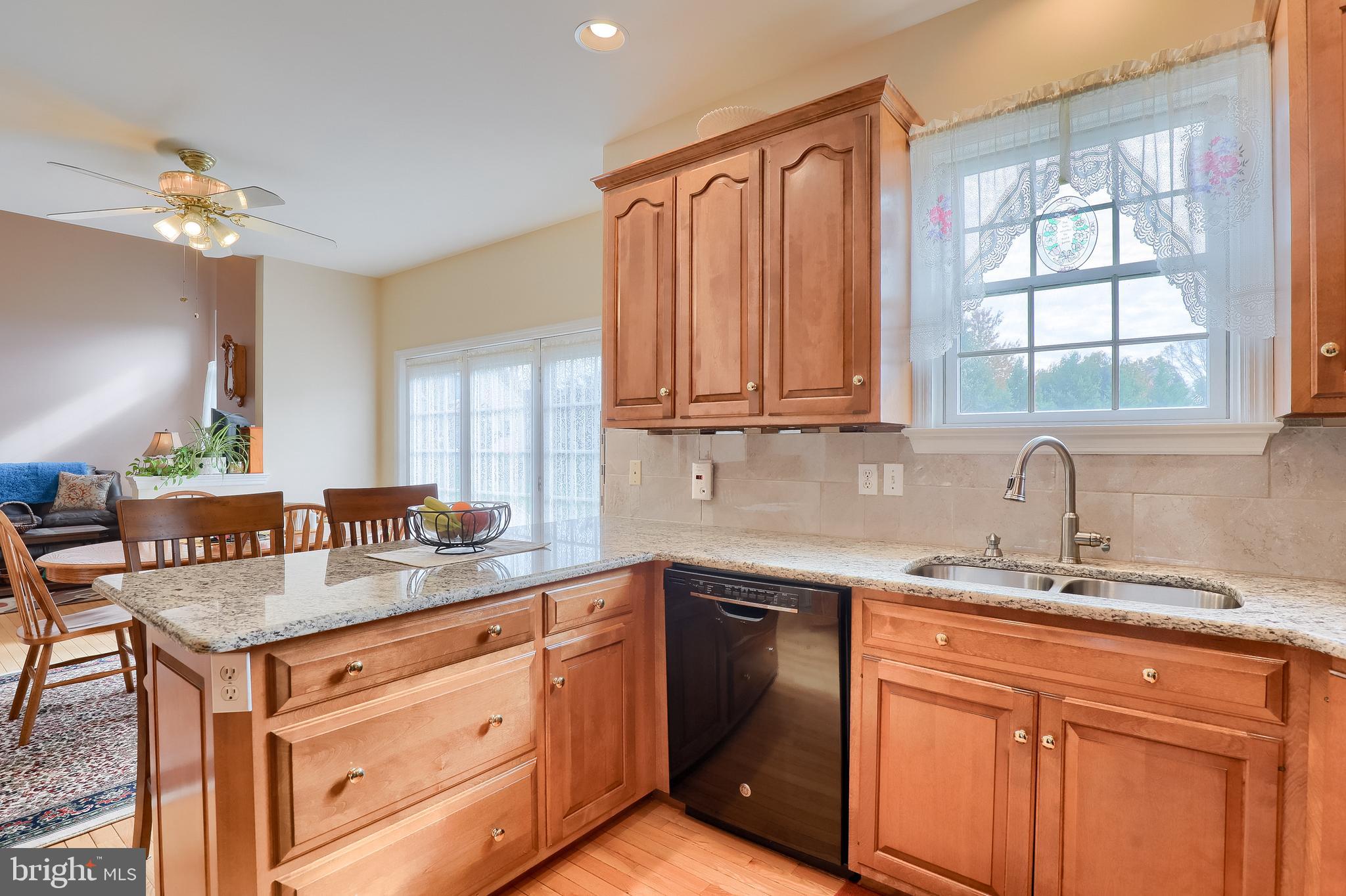 430 Wagonwheel Road Lititz, PA 17543 - Photo 21 of 51 a kitchen with stainless steel appliances granite countertop a sink a stove a dining table and chairs