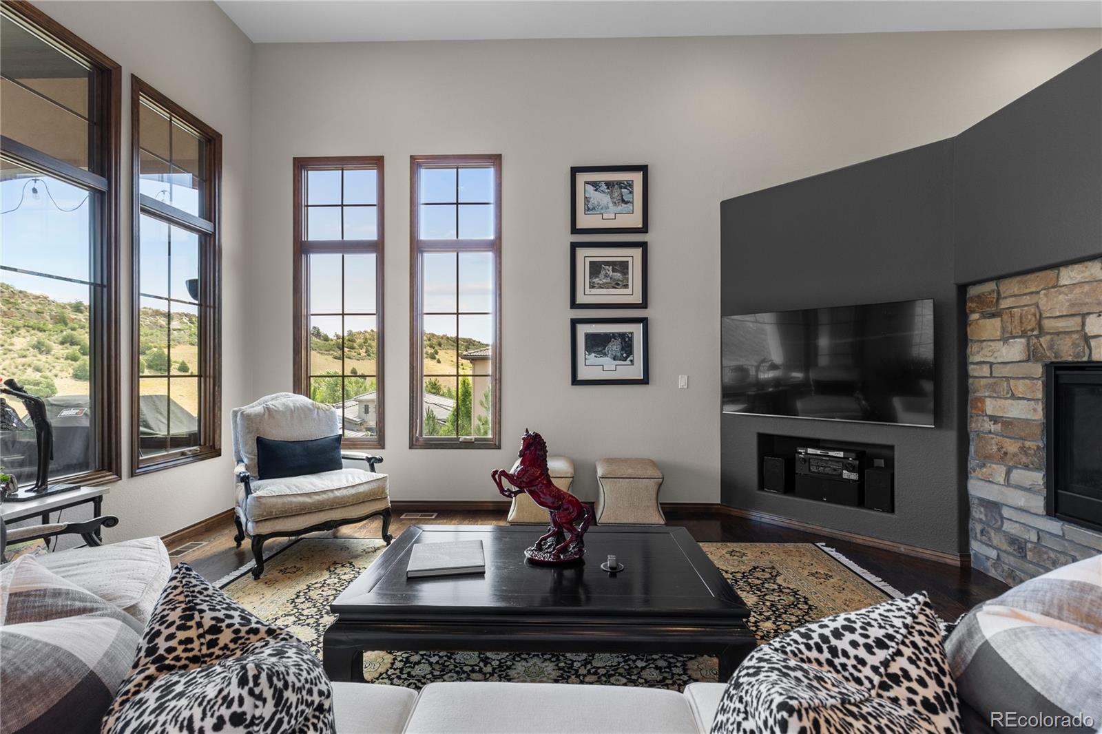 8000 Raphael Lane Littleton, CO 80125 - Photo 11 of 47 a living room with furniture a flat screen tv and a fireplace