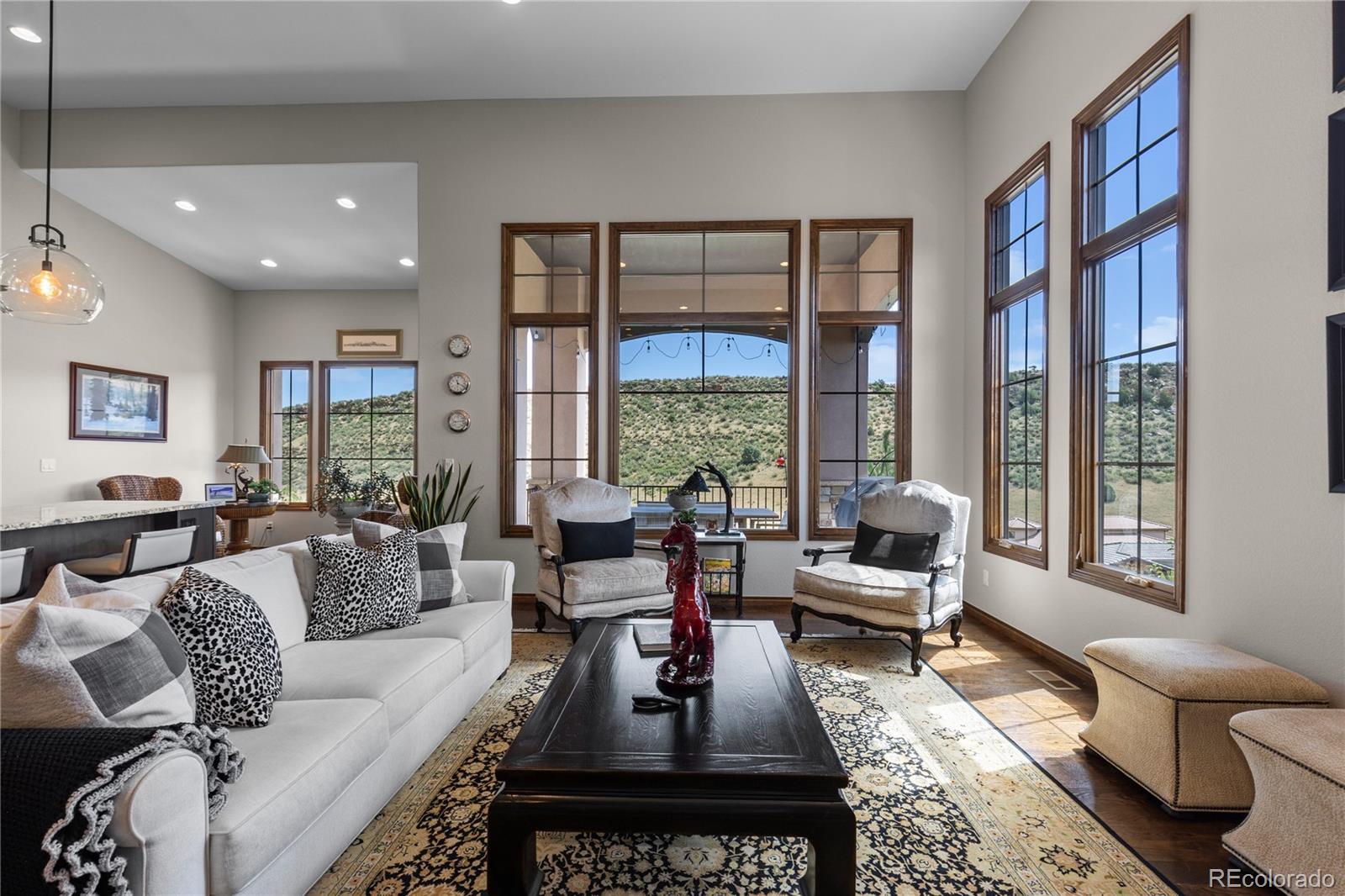 8000 Raphael Lane Littleton, CO 80125 - Photo 12 of 47 a living room with furniture and a large window