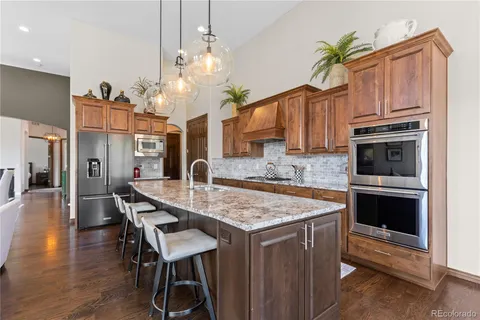 a kitchen with a table a sink and cabinets