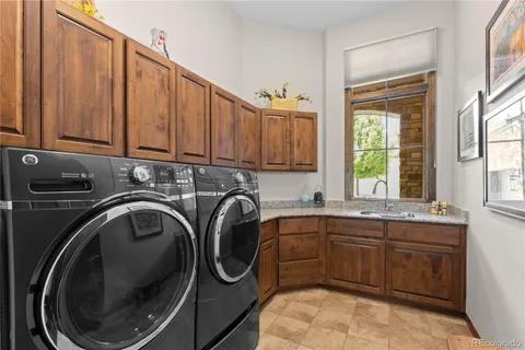 a utility room with sink dryer and washer