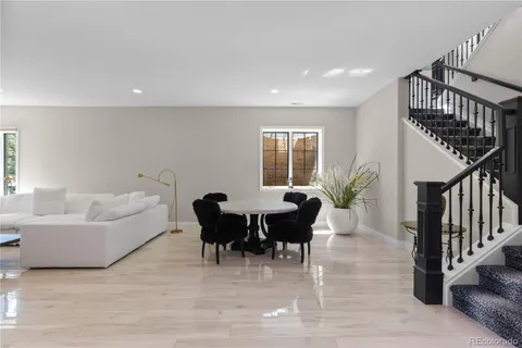 a living room with furniture a dining table and a potted plant