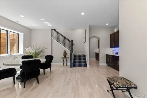 a living room with furniture flat screen tv and chairs