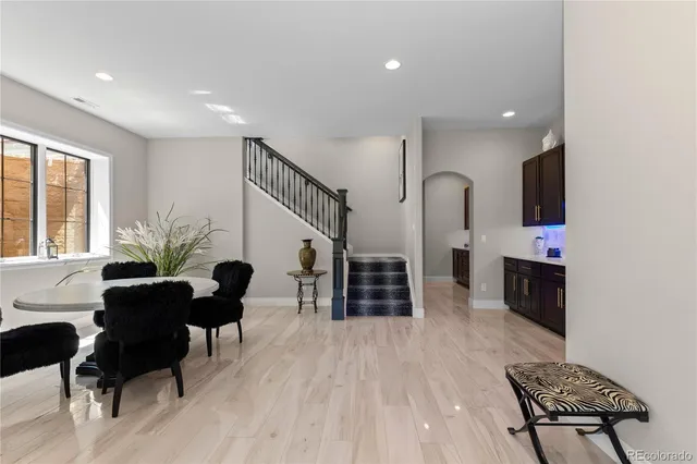 a living room with furniture flat screen tv and chairs