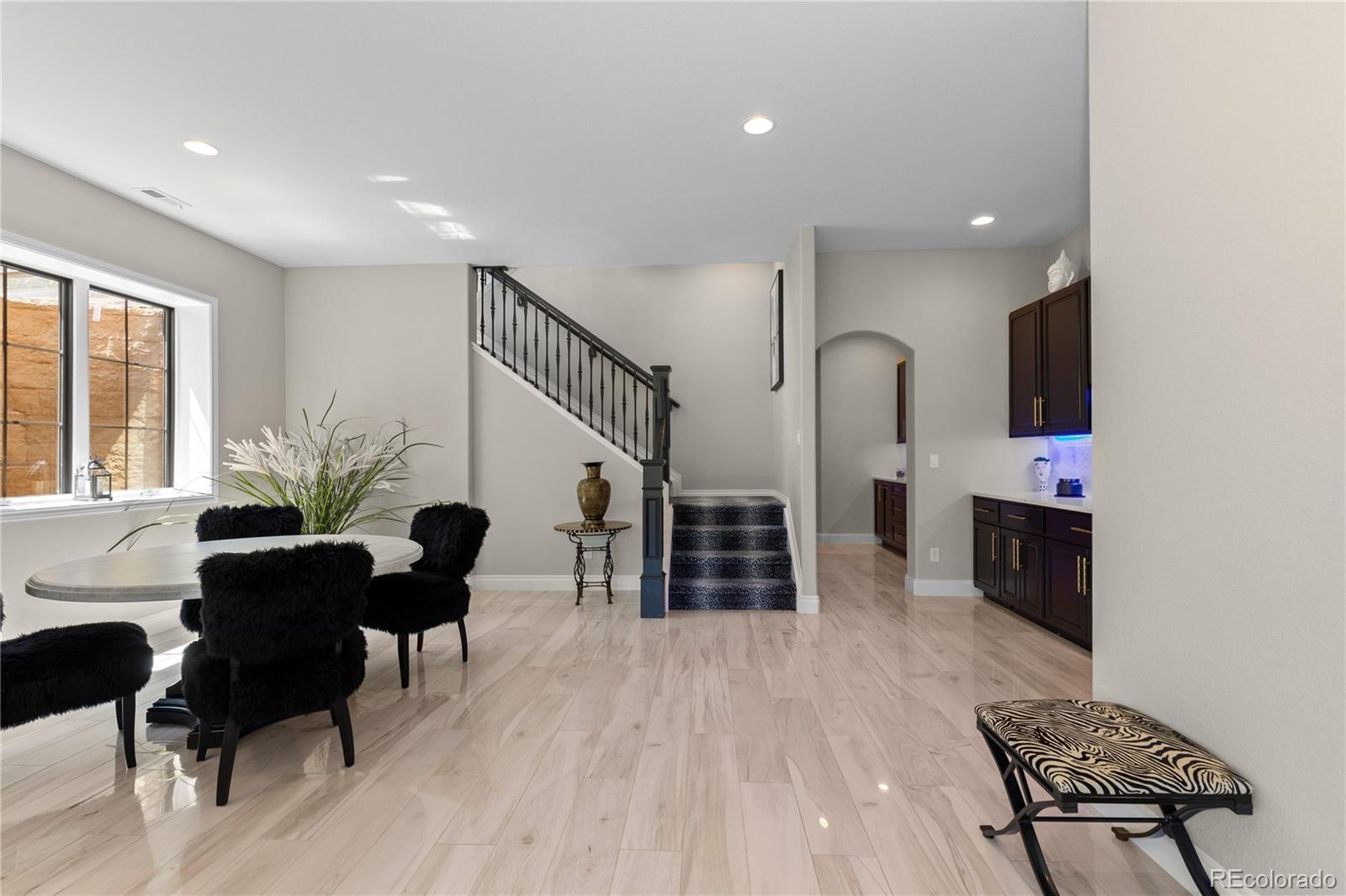 8000 Raphael Lane Littleton, CO 80125 - Photo 26 of 47 a living room with furniture flat screen tv and chairs