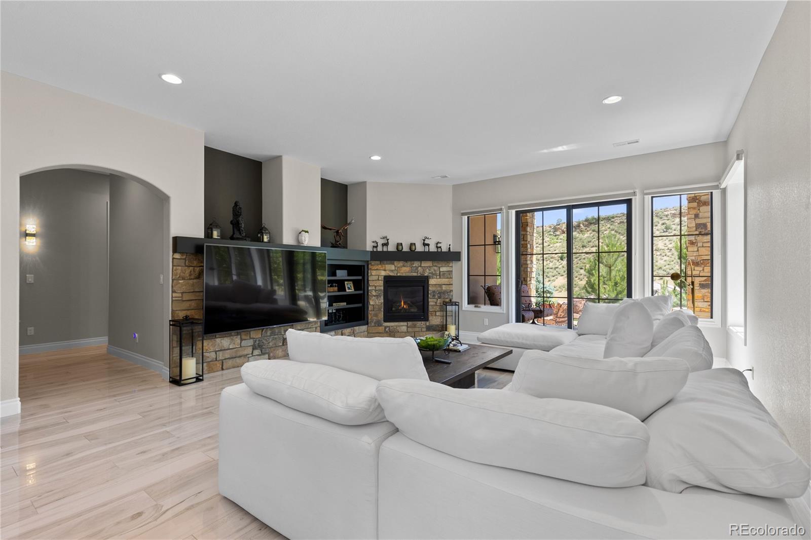 8000 Raphael Lane Littleton, CO 80125 - Photo 27 of 47 a living room with furniture and a fireplace