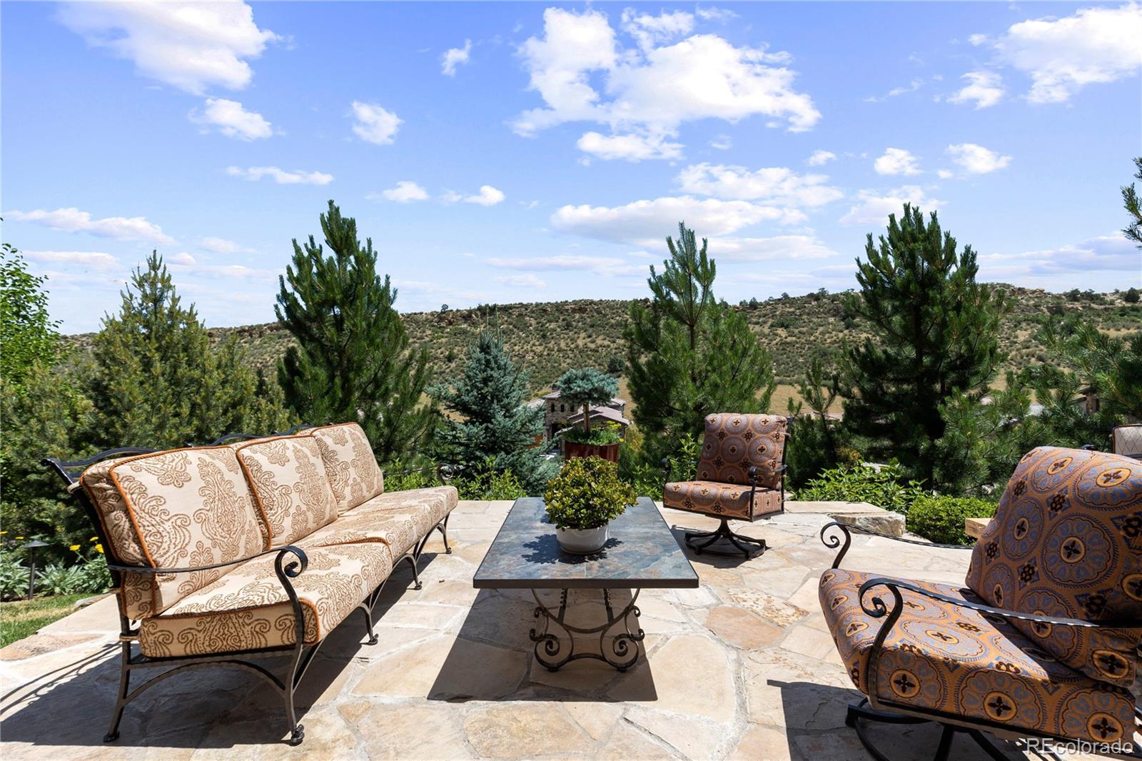 8000 Raphael Lane Littleton, CO 80125 - Photo 3 of 47 a view of a patio with couches and table and chairs with wooden fence