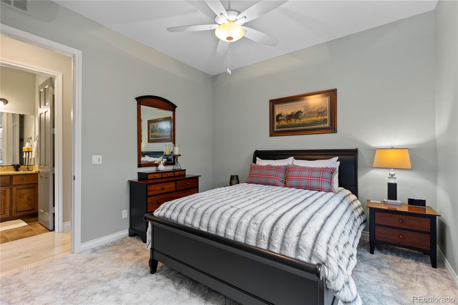 8000 Raphael Lane Littleton, CO 80125 - Photo 35 of 47 a bedroom with a bed and a chandelier