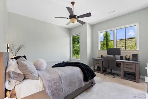 a bedroom with a bed and a large window