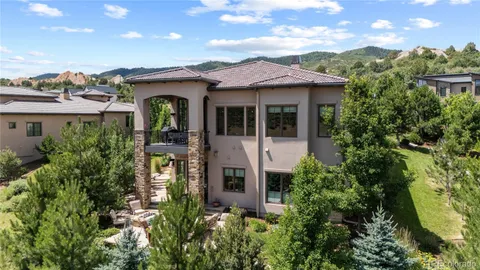an aerial view of a house with a yard and potted plants
