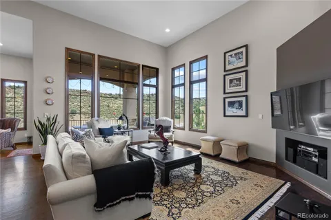 a living room with furniture large window and a table