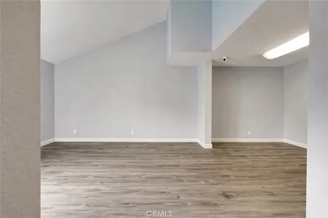 a view of an empty room and wooden floor