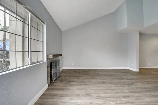 a view of a kitchen with wooden floor and iron stairs