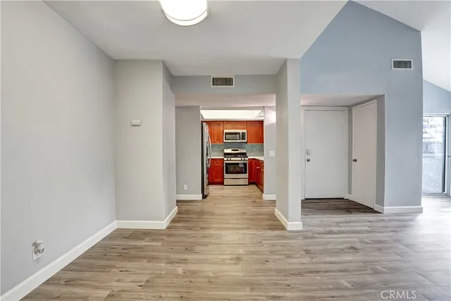 a view of a hallway with wooden floor