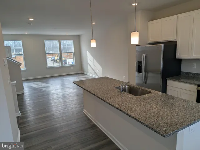 a kitchen with stainless steel appliances granite countertop a sink window and refrigerator