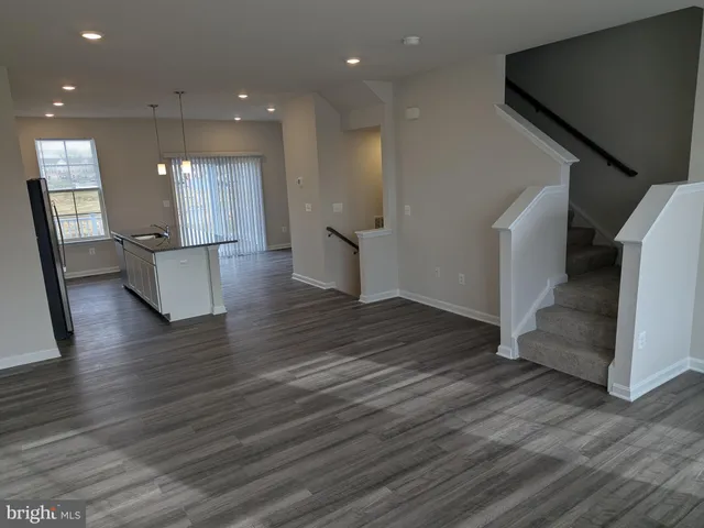 a view of kitchen with furniture and wooden floor