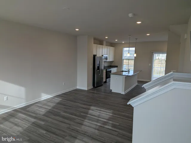 a view of kitchen with refrigerator and window