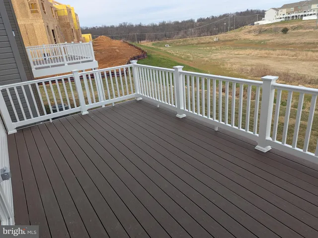a balcony with wooden floor and lake view