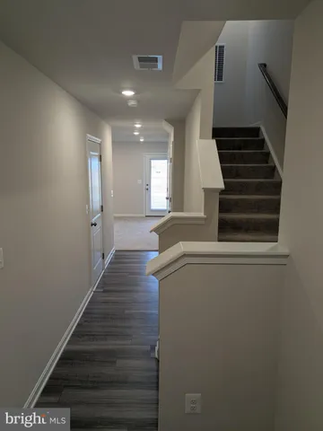 a view of entryway and hall with wooden floor