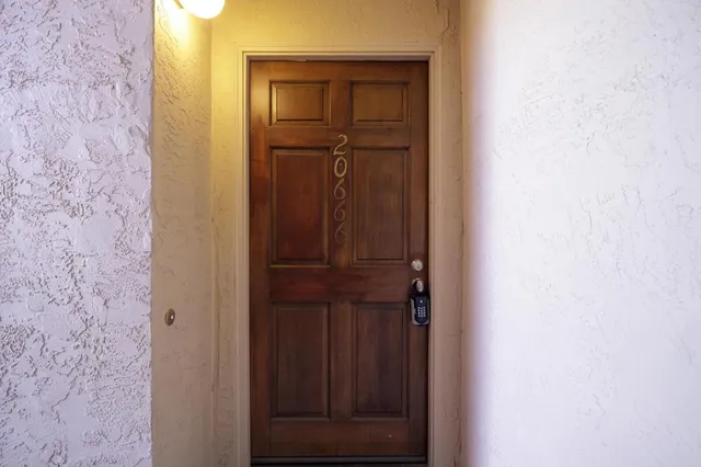 a view of a small space with wooden floor and a window