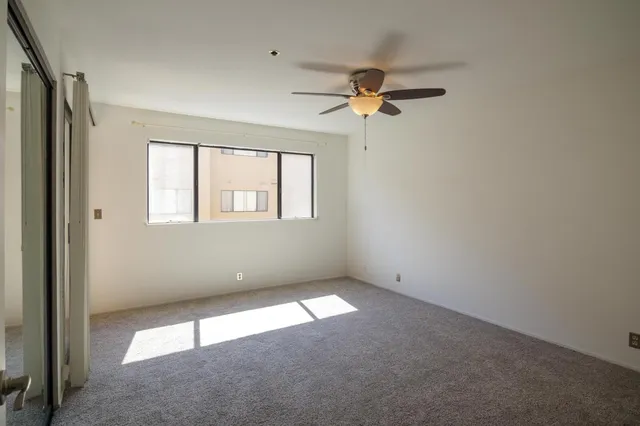 a bathroom with a glass shower door and a mirror