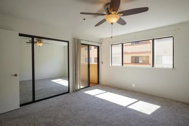 a front view of a house with a yard and potted plants