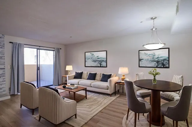 a living room with furniture a lamp and a chandelier