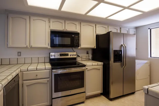 a kitchen with a refrigerator stove and microwave