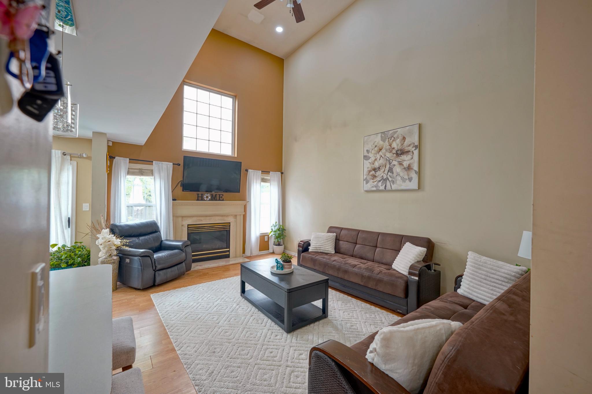 8 Saw Mill Drive Mount Laurel, NJ 08054 - Photo 16 of 37 a living room with furniture a fireplace and a flat screen tv