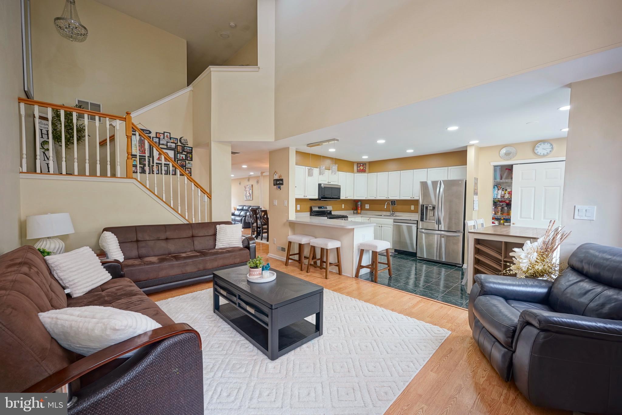 8 Saw Mill Drive Mount Laurel, NJ 08054 - Photo 17 of 37 a living room with furniture kitchen view and a wooden floor