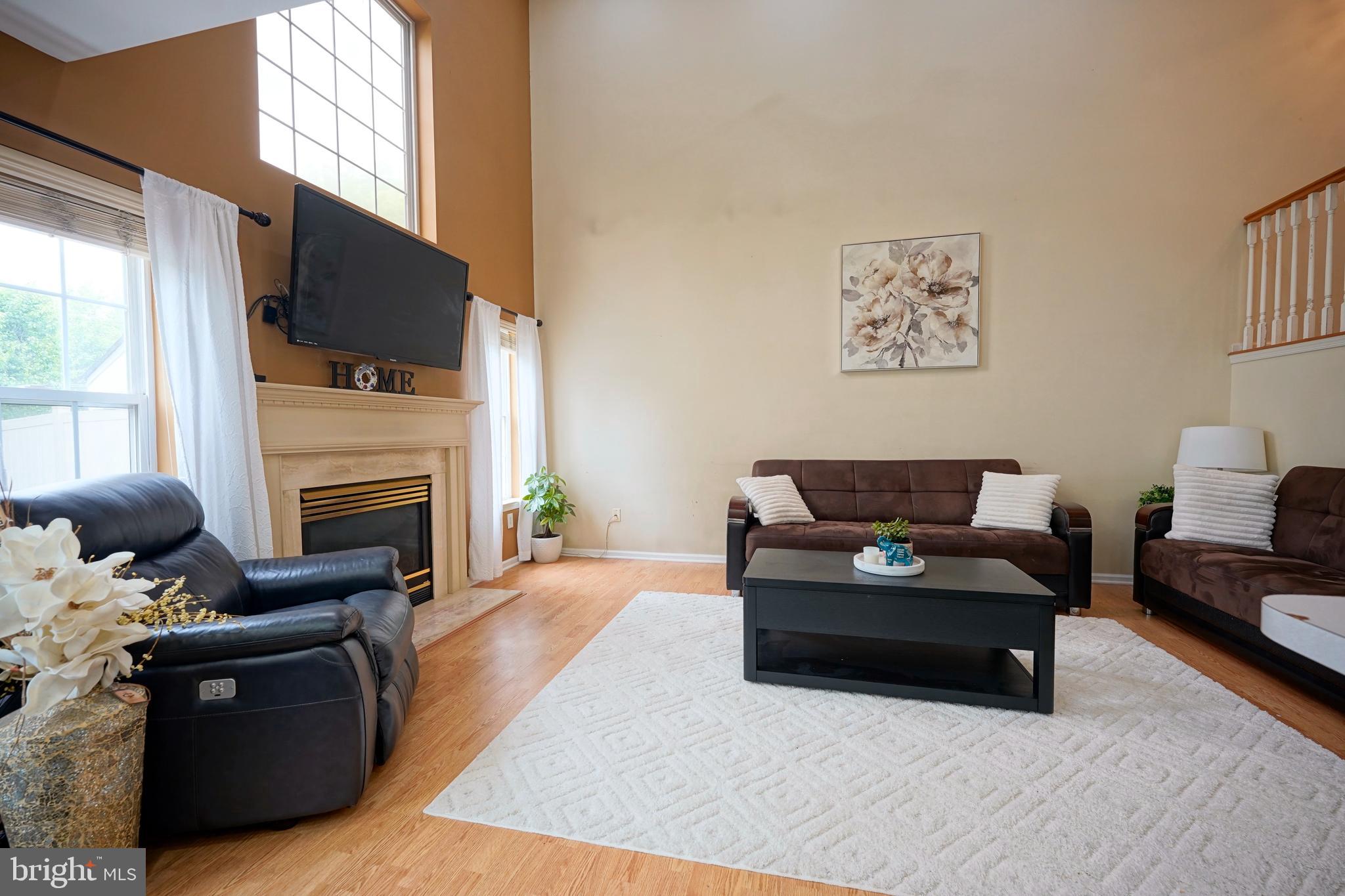 8 Saw Mill Drive Mount Laurel, NJ 08054 - Photo 18 of 37 a living room with furniture a flat screen tv and a fireplace