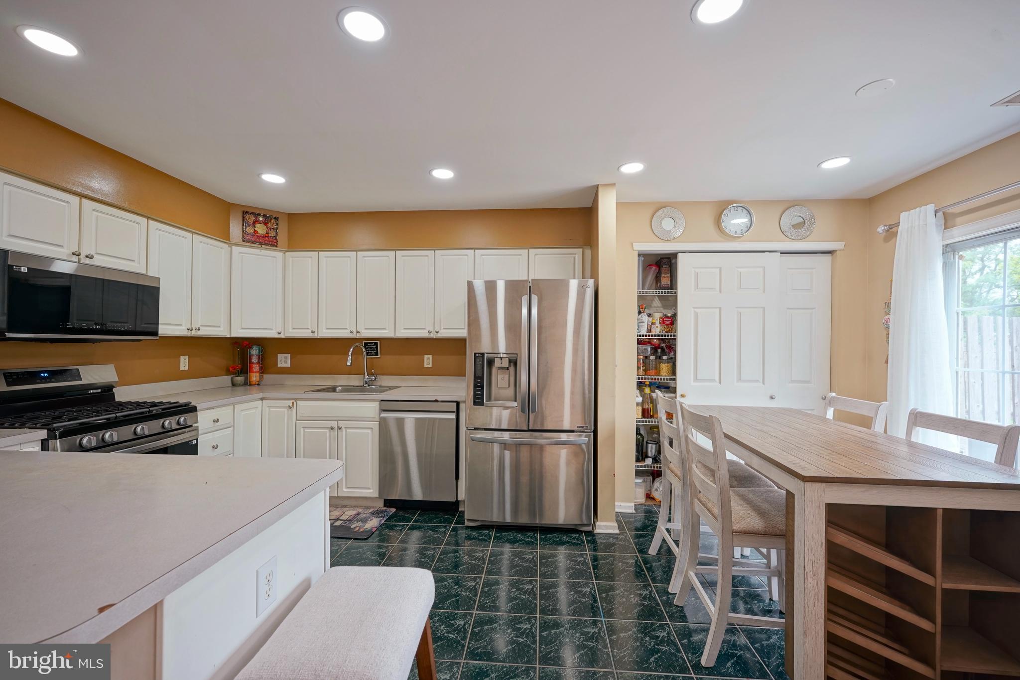 8 Saw Mill Drive Mount Laurel, NJ 08054 - Photo 21 of 37 a kitchen with a refrigerator a sink and cabinets