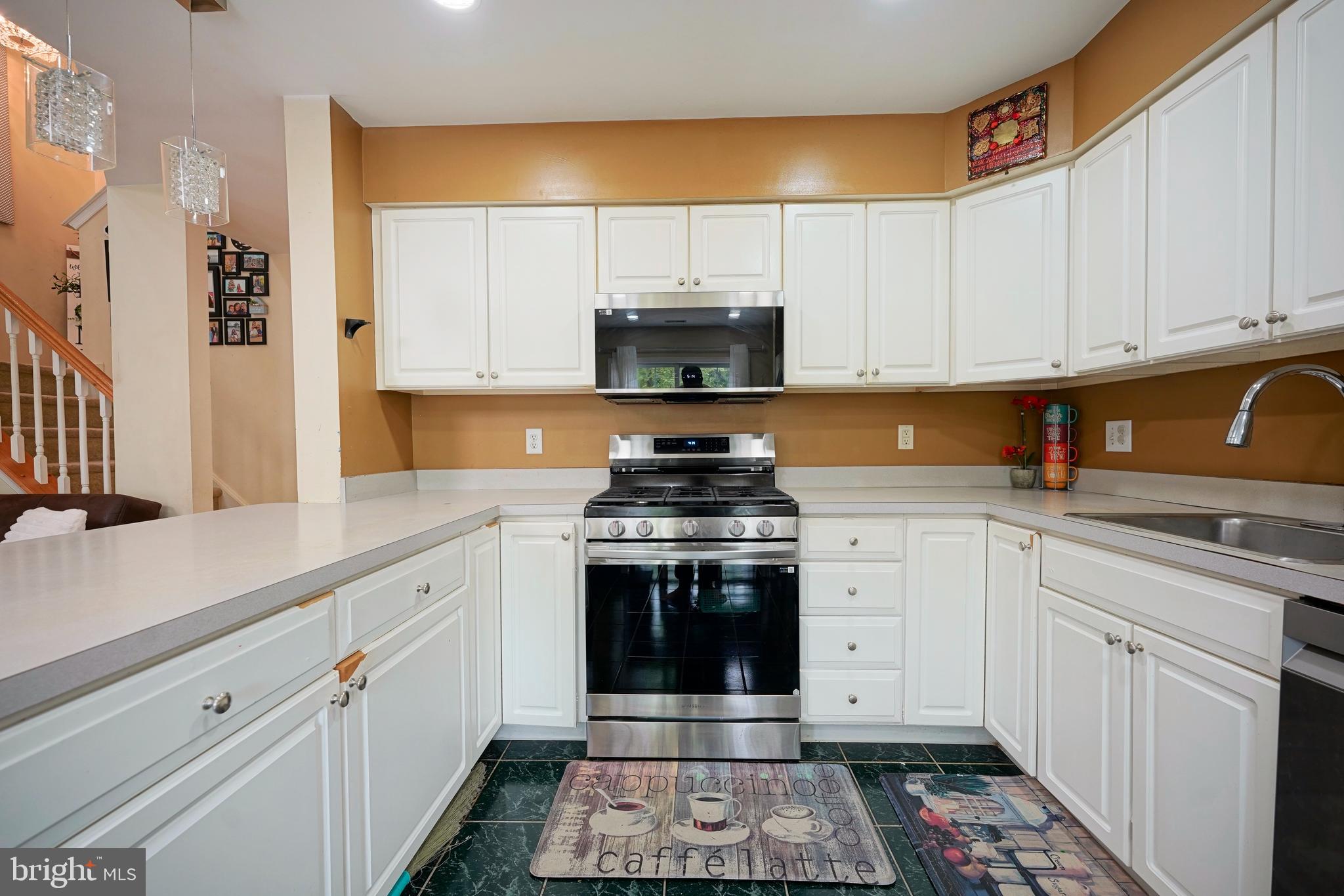 8 Saw Mill Drive Mount Laurel, NJ 08054 - Photo 22 of 37 a kitchen with a stove and white cabinets