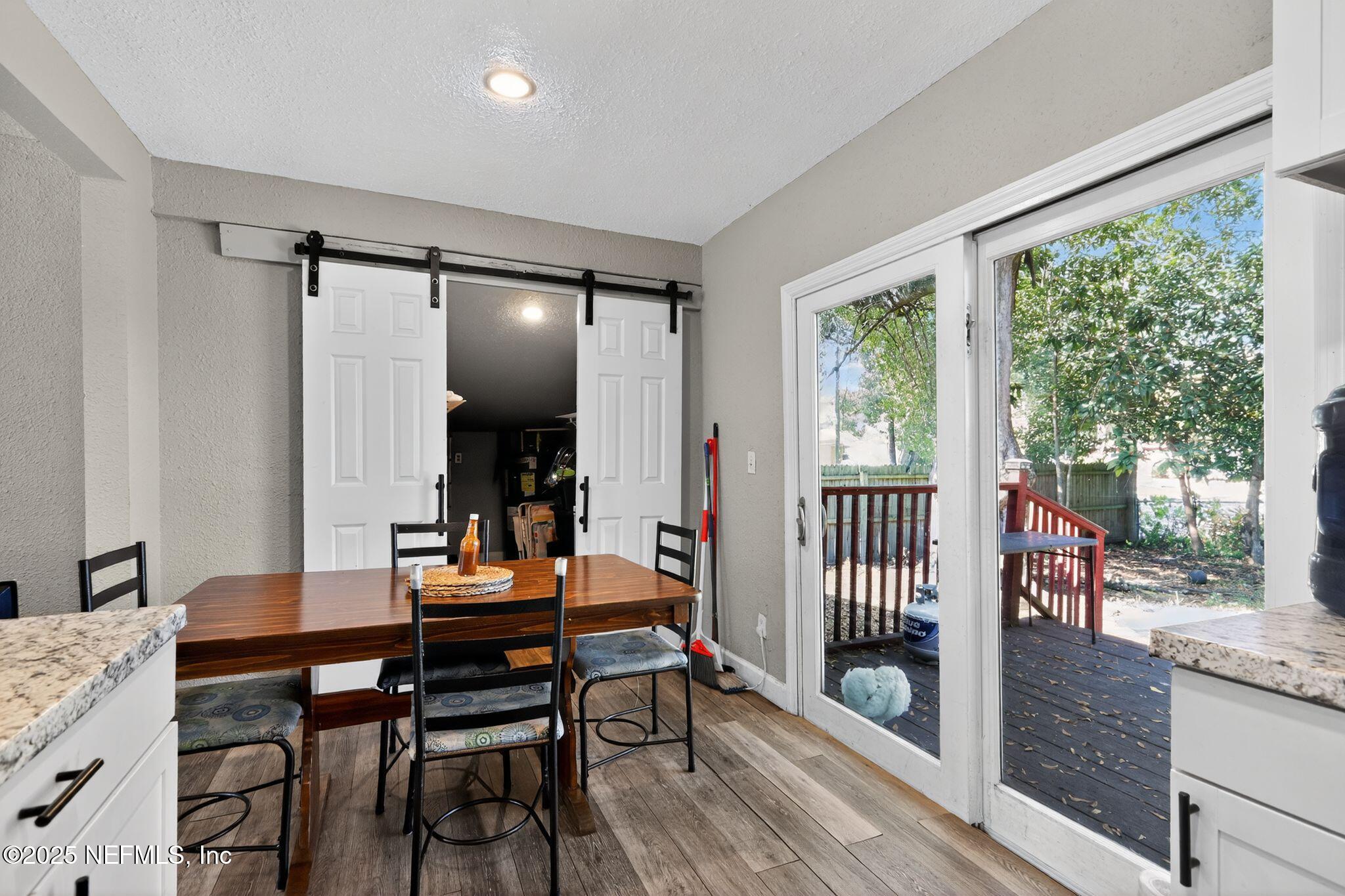 2181 West 17th Street Jacksonville, FL 32209 - Photo 13 of 27 a view of a dining room with furniture window and wooden floor