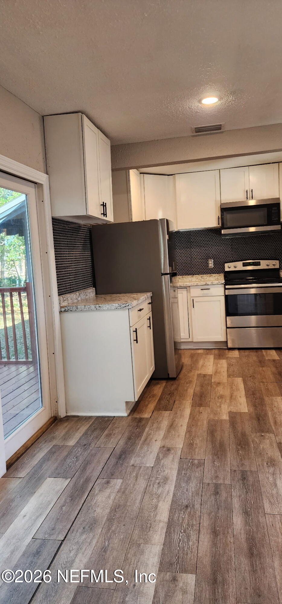 2181 West 17th Street Jacksonville, FL 32209 - Photo 18 of 27 a view of kitchen with cabinets and wooden floor