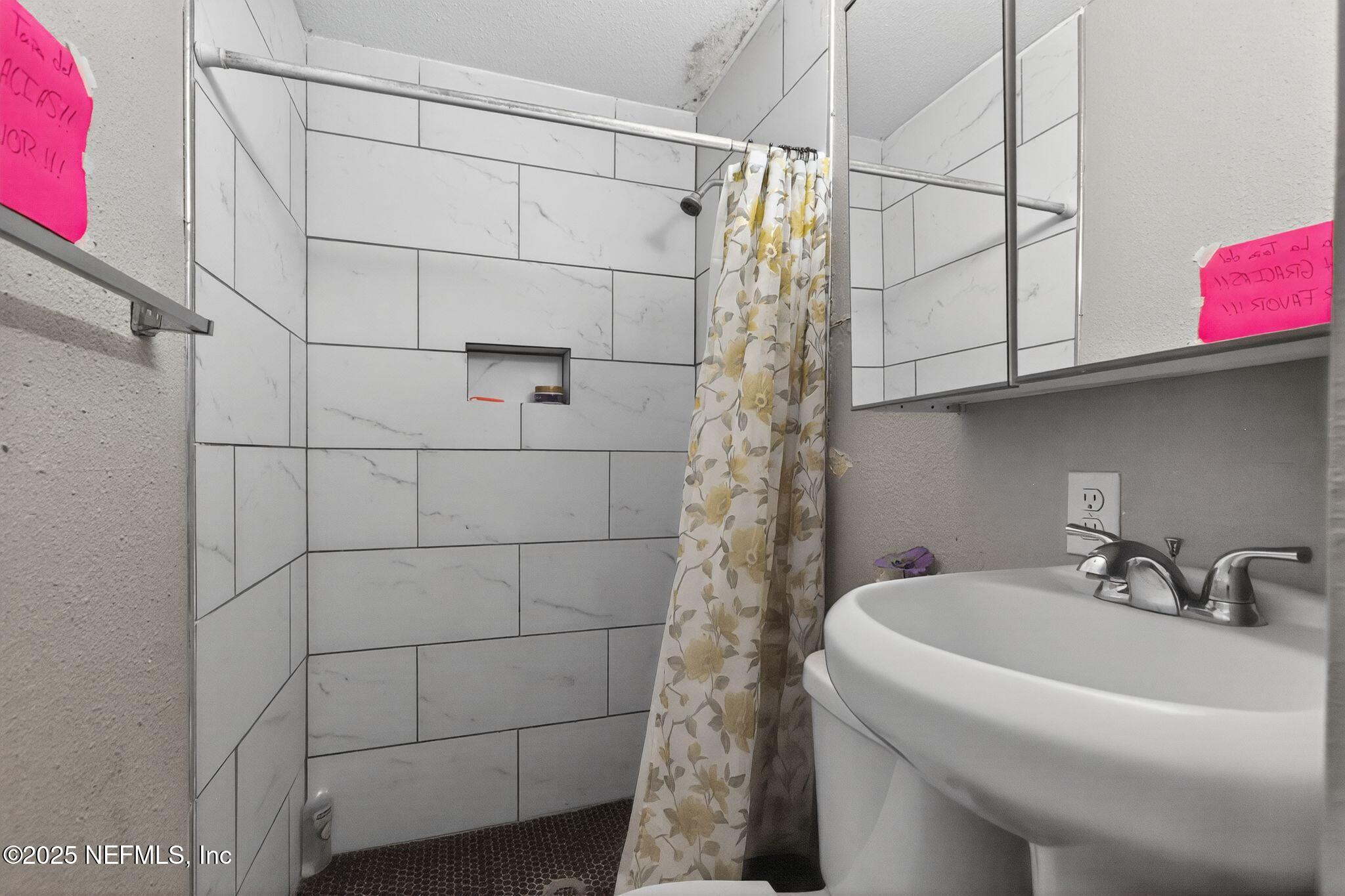 2181 West 17th Street Jacksonville, FL 32209 - Photo 20 of 27 a bathroom with a sink and shower