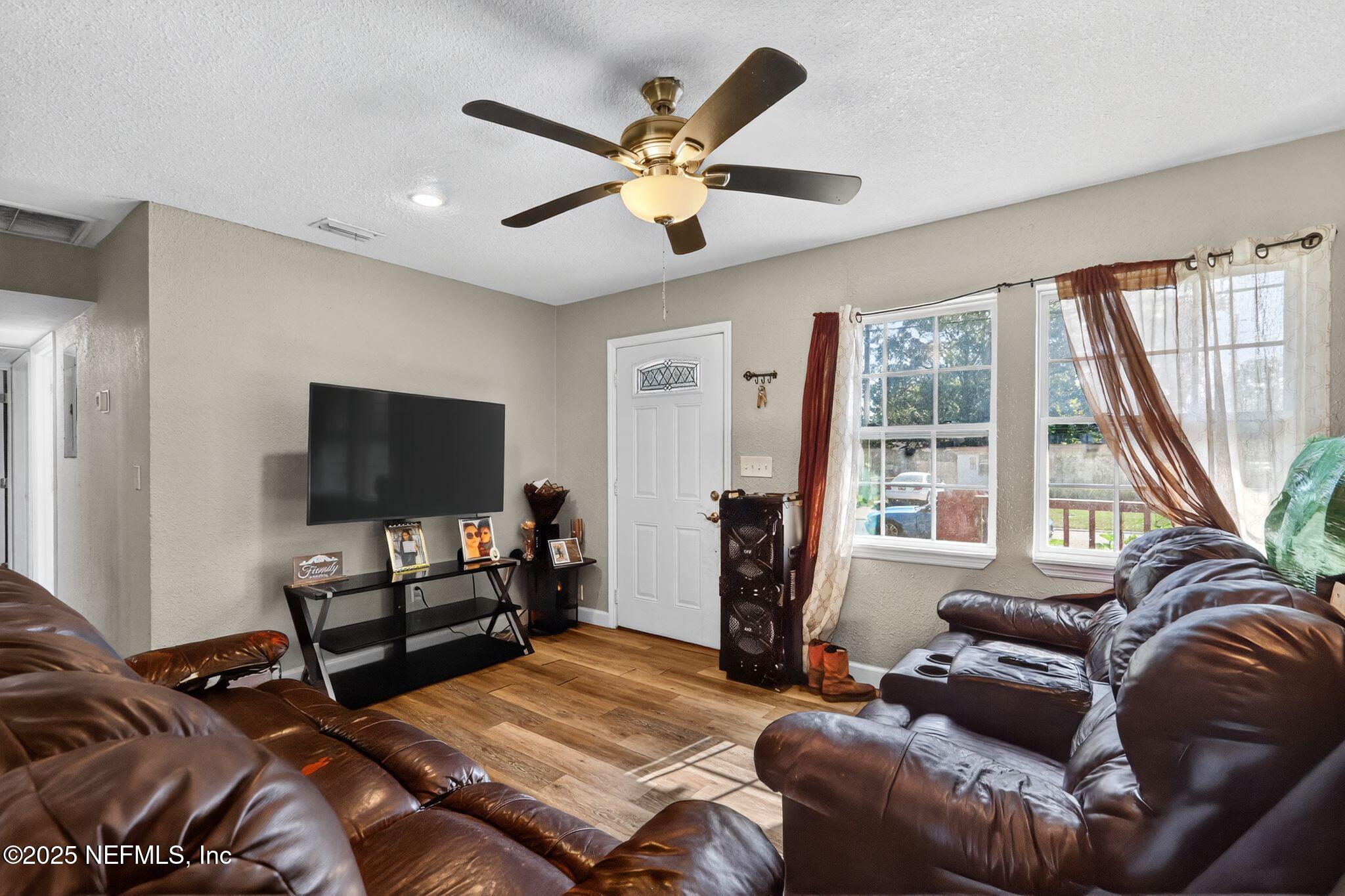 2181 West 17th Street Jacksonville, FL 32209 - Photo 6 of 27 a living room with furniture and a flat screen tv