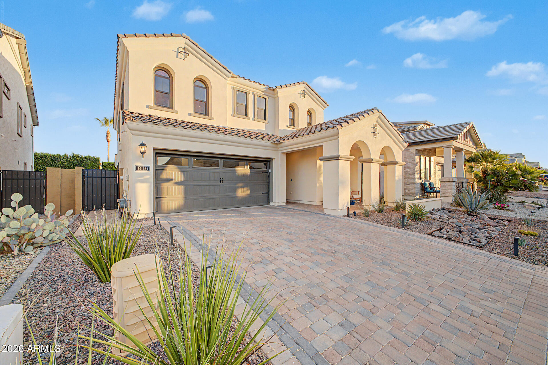 819 West Deer Creek Road Phoenix, AZ 85048 - Photo 10 of 76 a view of a white house with wooden walls and potted plants