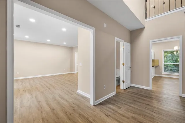 a view of a hallway with wooden floor