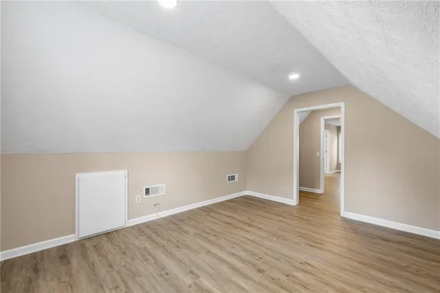 wooden floor in a hall with an empty room