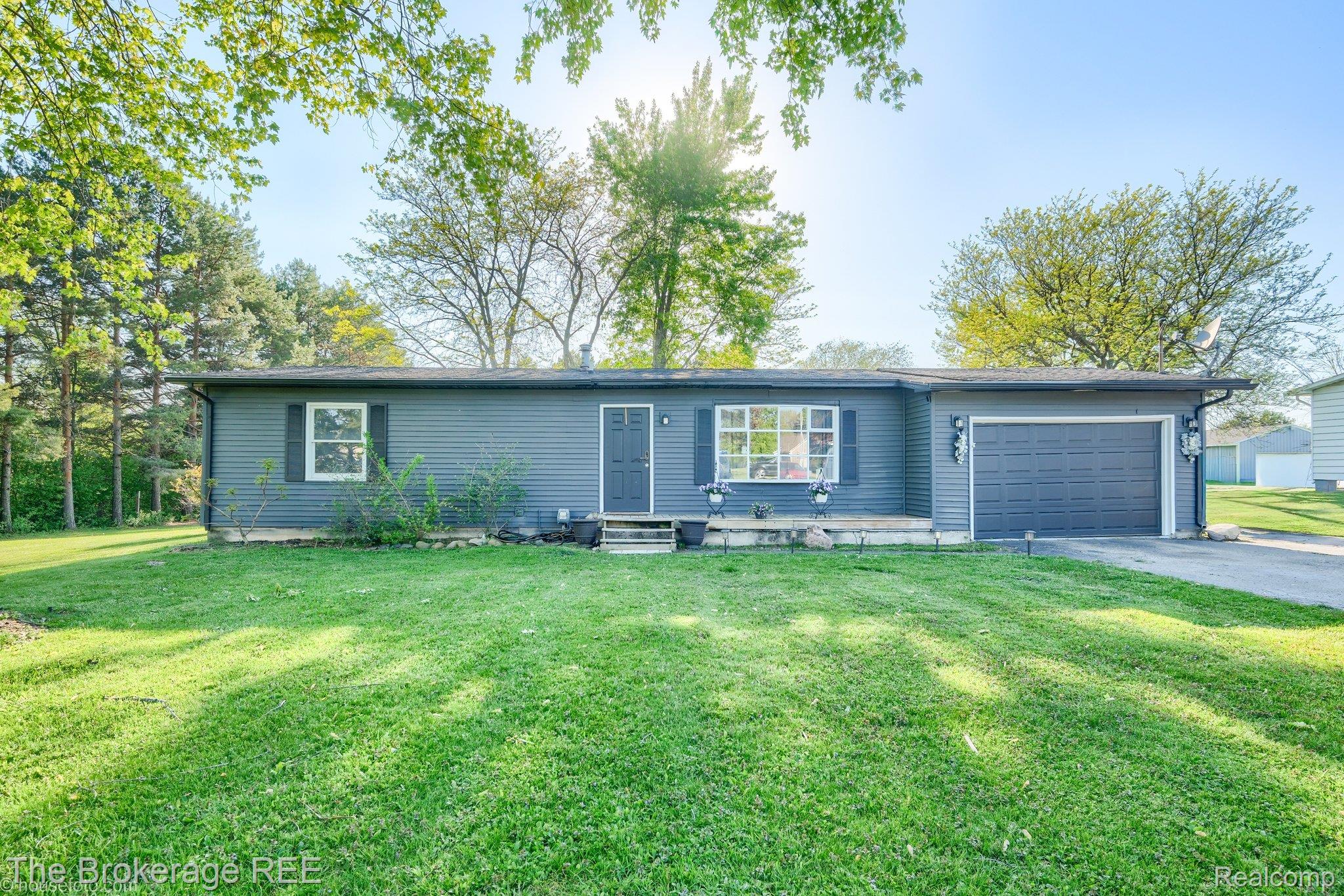 6288 Porter Road Grand Blanc, MI 48439 - Photo 1 of 39 Single story home with an attached garage, asphalt driveway, a front yard, and entry steps