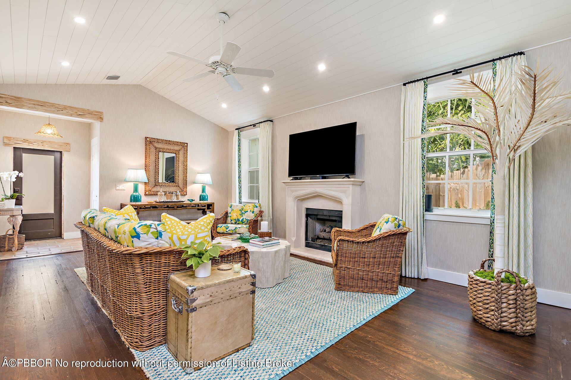 7610 Washington Road West Palm Beach, FL 33405 - Photo 2 of 12 a living room with fireplace furniture and a flat screen tv