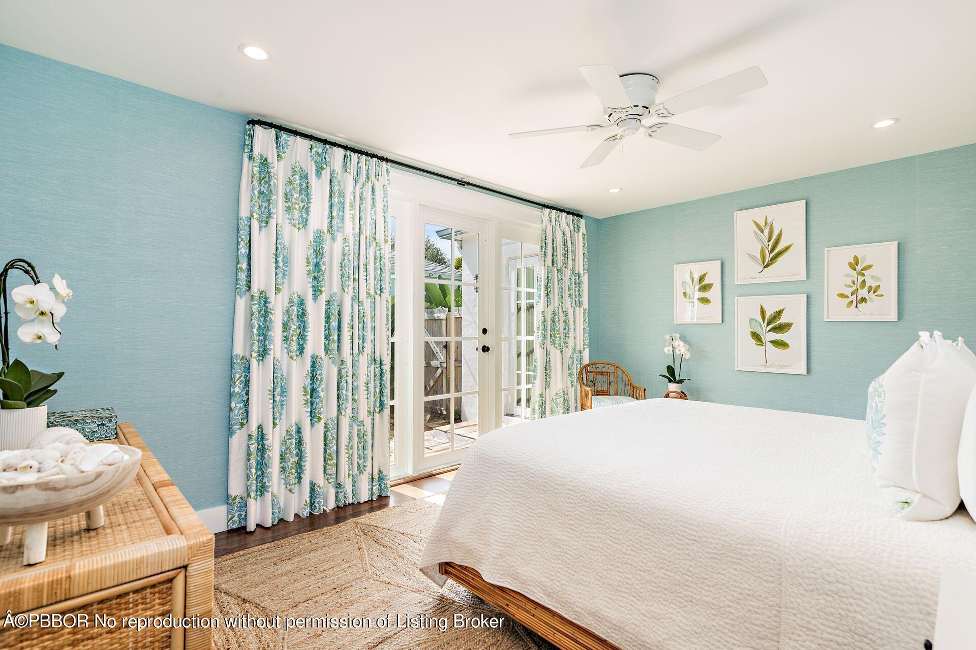 7610 Washington Road West Palm Beach, FL 33405 - Photo 5 of 12 a bedroom with a bed and a chandelier