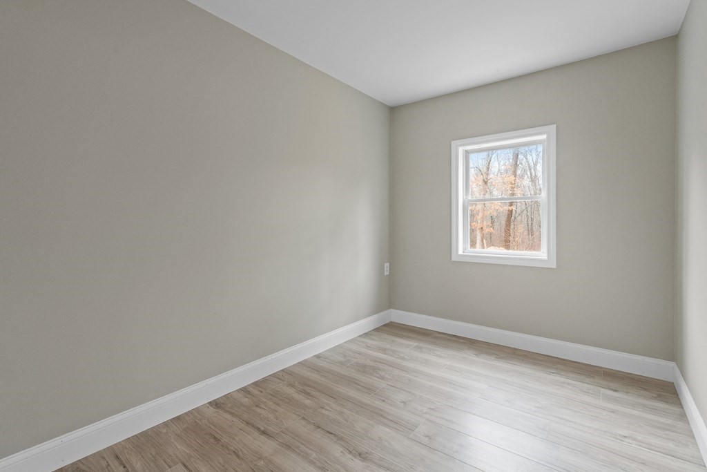 321 Winthrop Street Rehoboth, MA 02769 - Photo 11 of 16 wooden floor in an empty room with a window