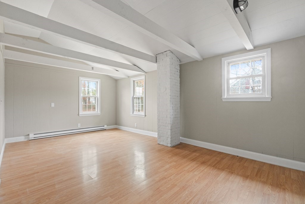 321 Winthrop Street Rehoboth, MA 02769 - Photo 12 of 16 a view of an empty room with wooden floor and a window
