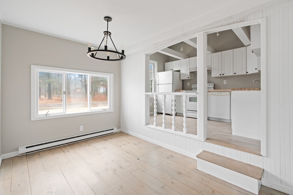 321 Winthrop Street Rehoboth, MA 02769 - Photo 6 of 16 a view of an empty room with wooden floor and a window