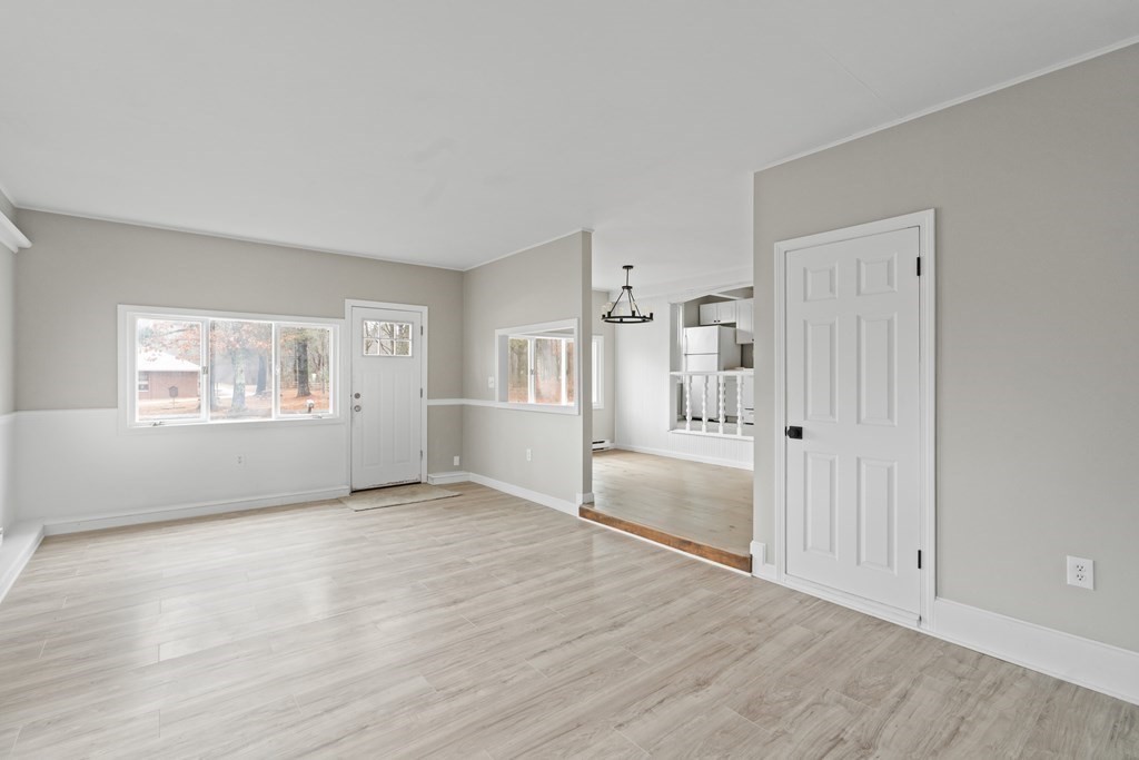 321 Winthrop Street Rehoboth, MA 02769 - Photo 8 of 16 a view of an empty room with a window and wooden floor